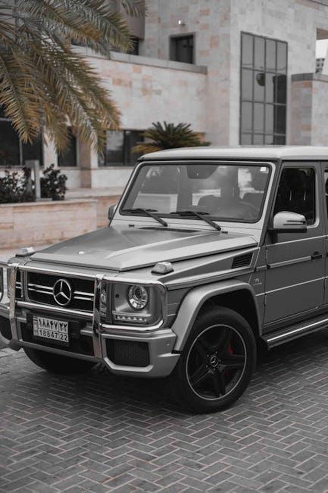 Aspettative_e_specifiche_del_nuovo_modello_WqD9FCeUGi - Veicoli24 Source: Ali Babajahdi - pexels - Stylish gray Mercedes G-Class SUV parked in modern urban setting.