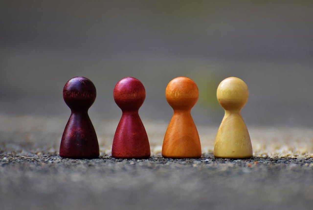 Collaborazione_con_Riot_Games_MENA_863oY0JYXI - Veicoli24 Source: Pixabay - pexels - Close-up of four colorful wooden pawn pieces arranged in a row.