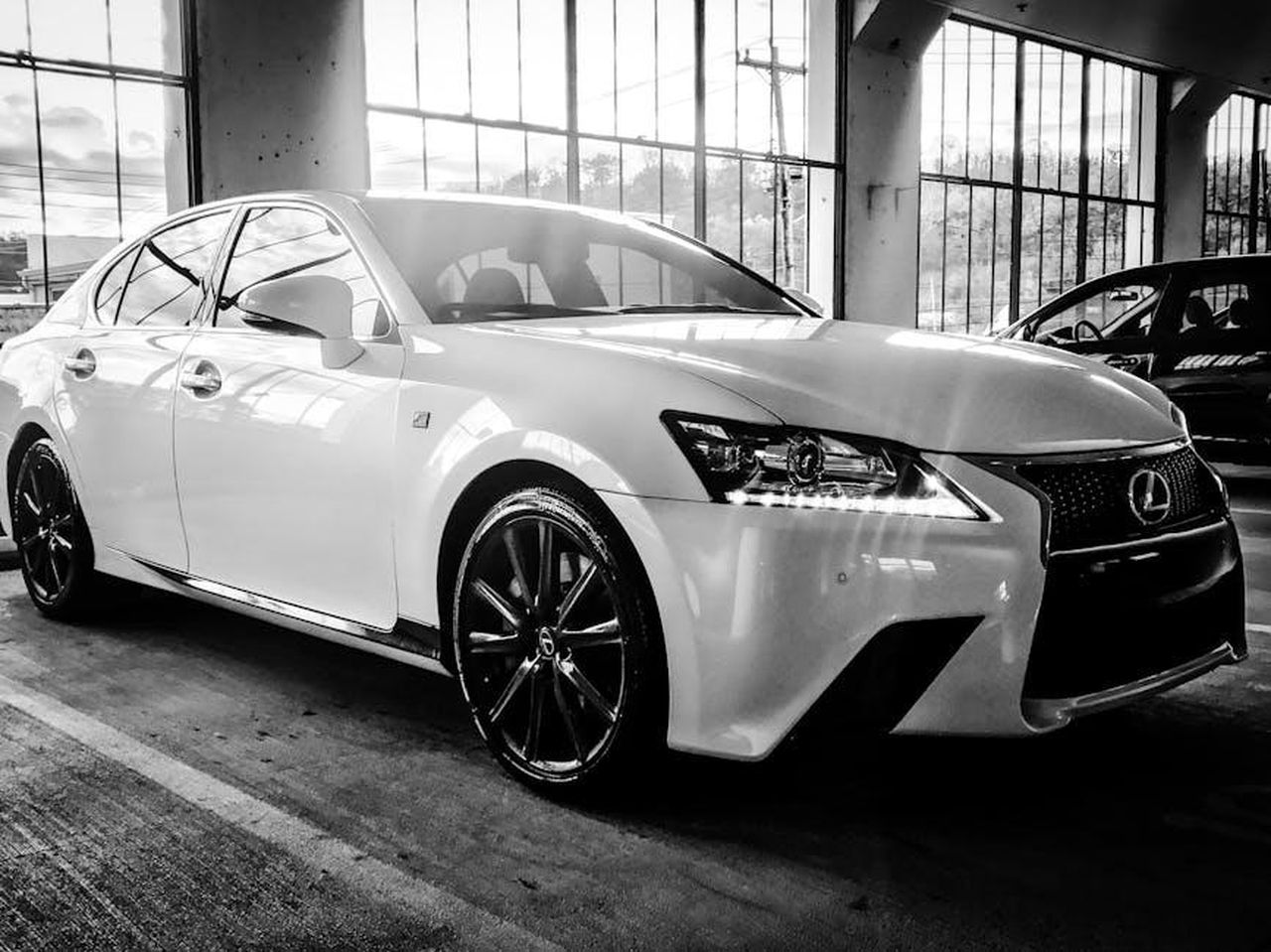 Comfort_e_qualit_della_Lexus_ES_2025_SPBr0TgVkS - Veicoli24 Source: Brice - pexels - A stylish Lexus sedan showcased in a black and white indoor setting, highlighting its luxury design.