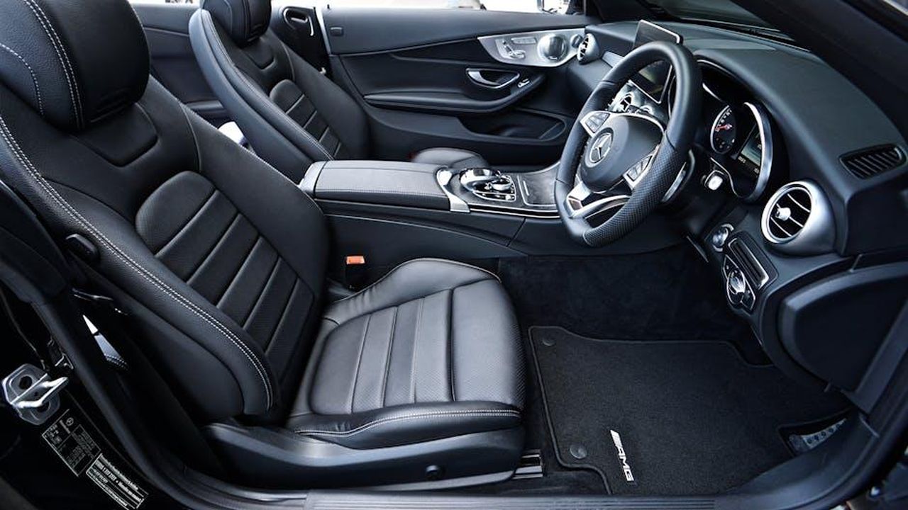 Configurazione_dei_sedili_e_funzionalit_aggiuntive_8LhihHapa4 - Veicoli24 Source: Mike Bird - pexels - Sleek black Mercedes-Benz interior featuring leather seats and modern dashboard design.