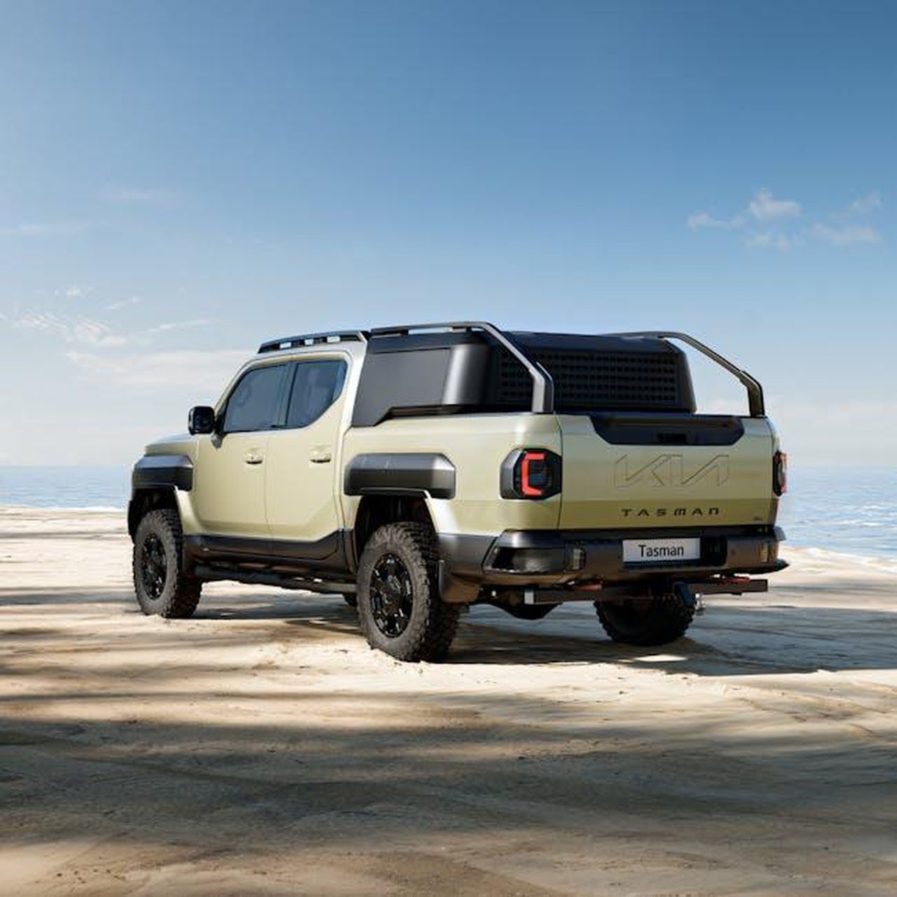 Design_e_caratteristiche_del_Kia_PV5_iIvGvvsyXm - Veicoli24 Source: Hyundai Motor Group - pexels - A sleek Kia Tasman pickup truck parked on a sunny beach with ocean views.