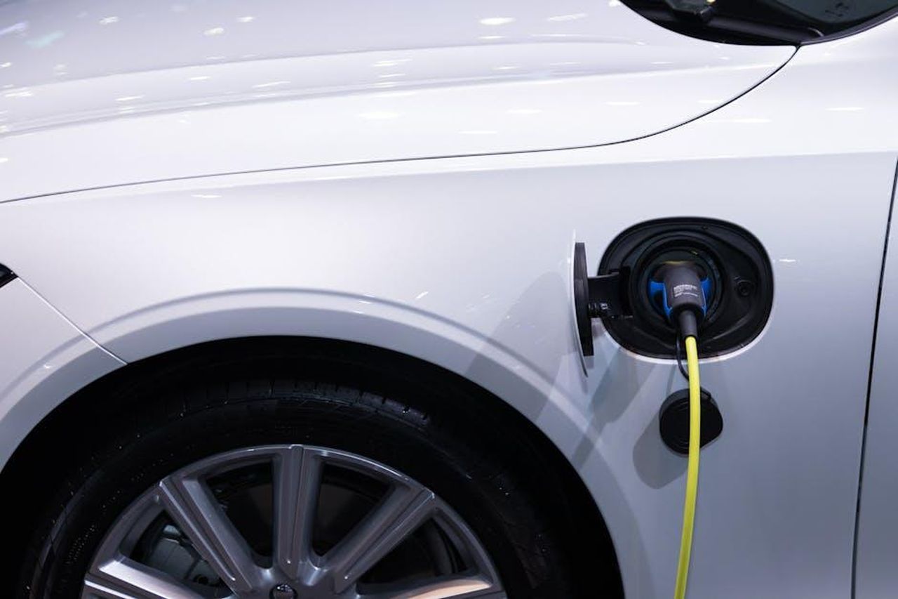 Dettagli_sulla_produzione_e_il_prezzo_35GjI9NrxN - Veicoli24 Source: Rathaphon Nanthapreecha - pexels - A white electric car is plugged in for charging, close-up view of the charging port.
