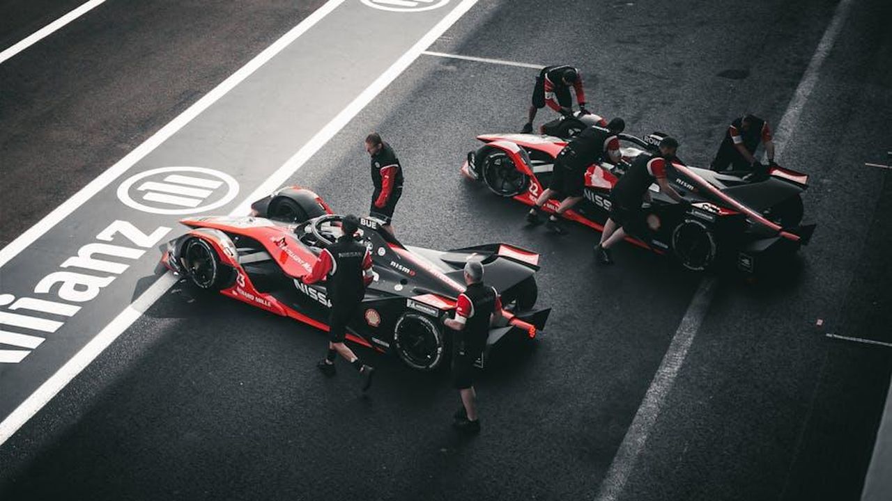 Il_futuro_della_tecnologia_ePower_di_Nissan_Fk70LCjrPe - Veicoli24 Source: Alex wolf mx - pexels - Pit crew working on race cars at a motorsport event in Mexico City.