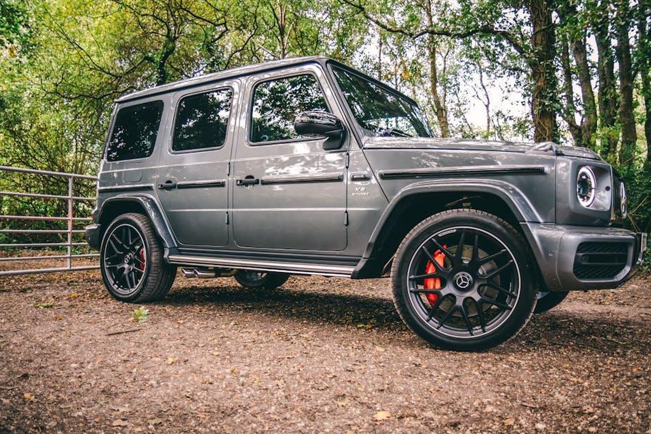 Iniziativa_Next_Level_Performance_AbMMR5MYzd - Veicoli24 Source: Lloyd Freeman - pexels - A luxurious Mercedes-Benz SUV parked in a scenic wooded area, showcasing elegance and power.