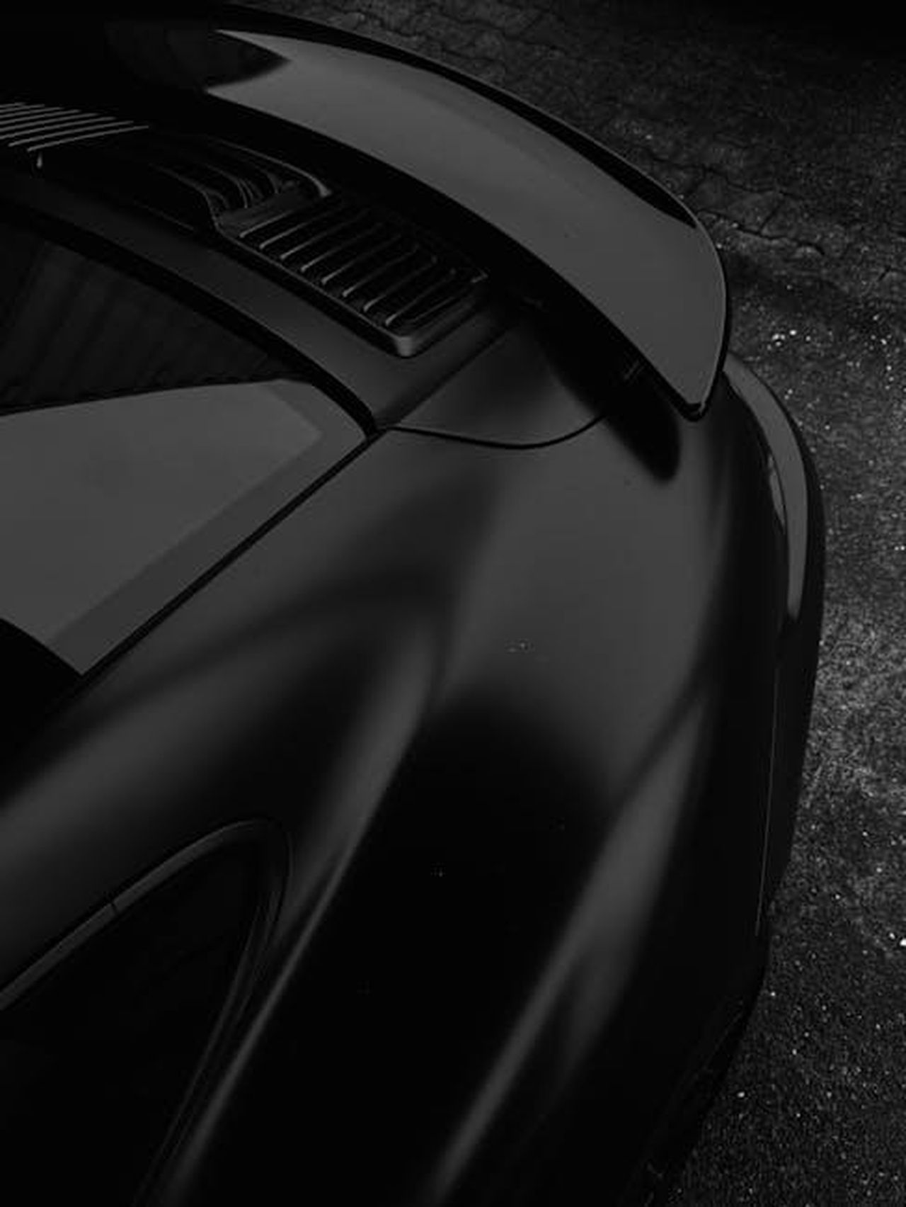 La_Nuova_Ypsilon_unevoluzione_stilistica_e_tecnologica_0MPzpqKqEx - Veicoli24 Source: Andreas Ebner - pexels - Sleek black high-performance sports car close-up, featuring aerodynamic design.
