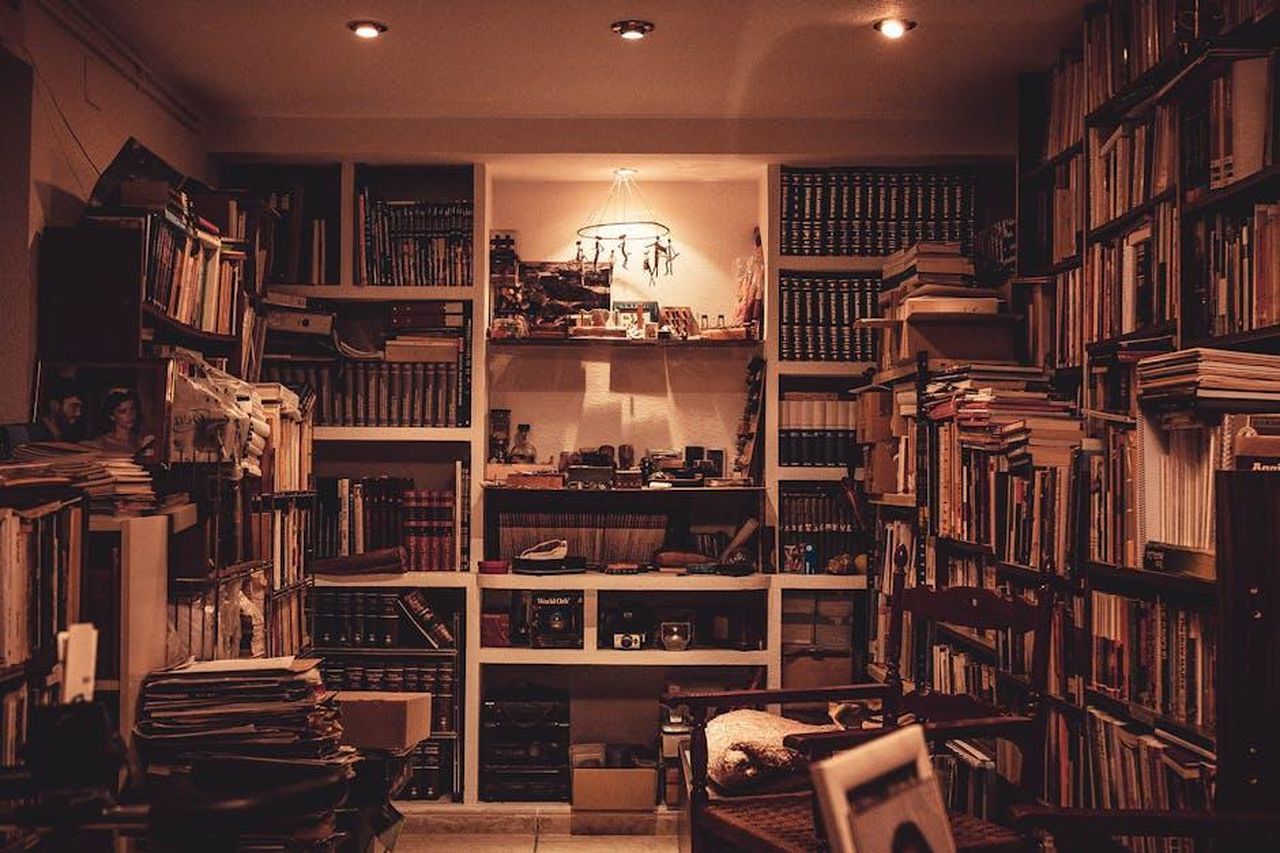 La_sala_motore_KMMTkezgnj - Veicoli24 Source: Juan Pablo Serrano - pexels - A warmly lit home library filled with a diverse collection of books and a cozy atmosphere.