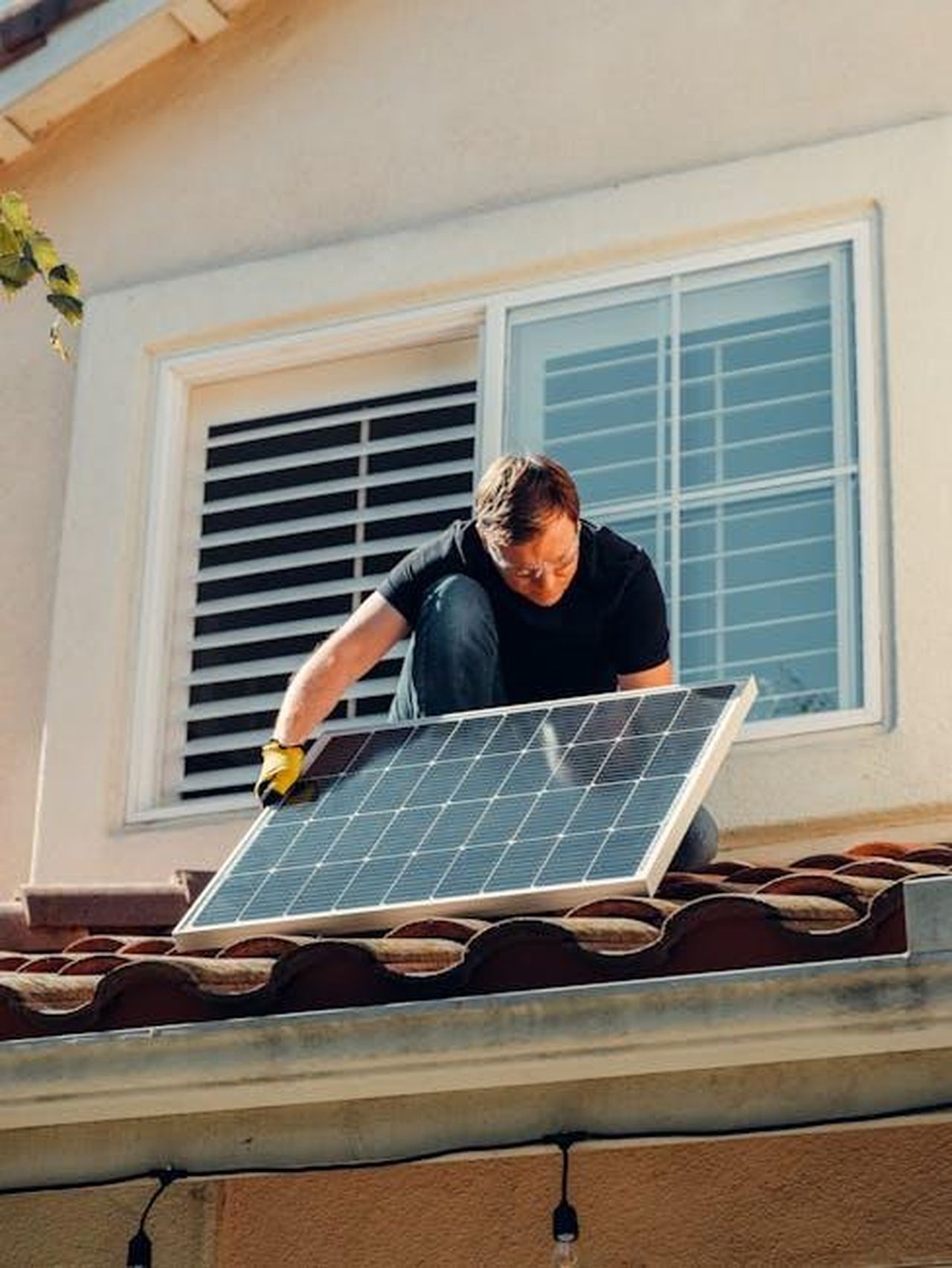 Nuova_generazione_di_batterie_ad_alta_densit_KCcyvqOi9U - Veicoli24 Source: Kindel Media - pexels - A worker installing a solar panel on a residential rooftop under bright sunlight.
