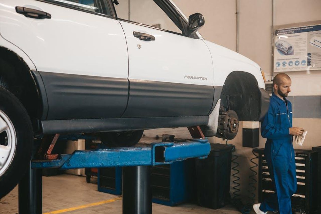 Valutazione_delle_Capacit_del_Lada_PIu28Ext4z - Veicoli24 Source: Artem Podrez - pexels - Mechanic evaluating a car on a lift for maintenance in an auto workshop.